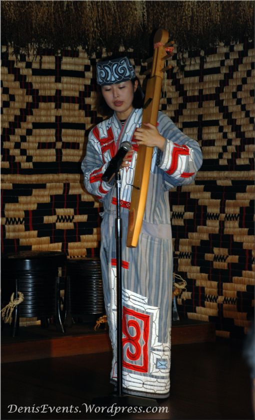 Women Musician playing the tonkori (plucked string instrument) in Shiraoi, Hokkaido